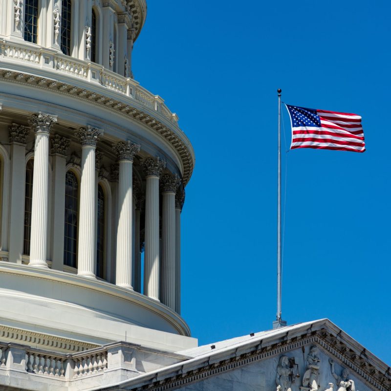 A low angle closeup of The United States Capitol under the sunlight and a blue sky in Washington DC